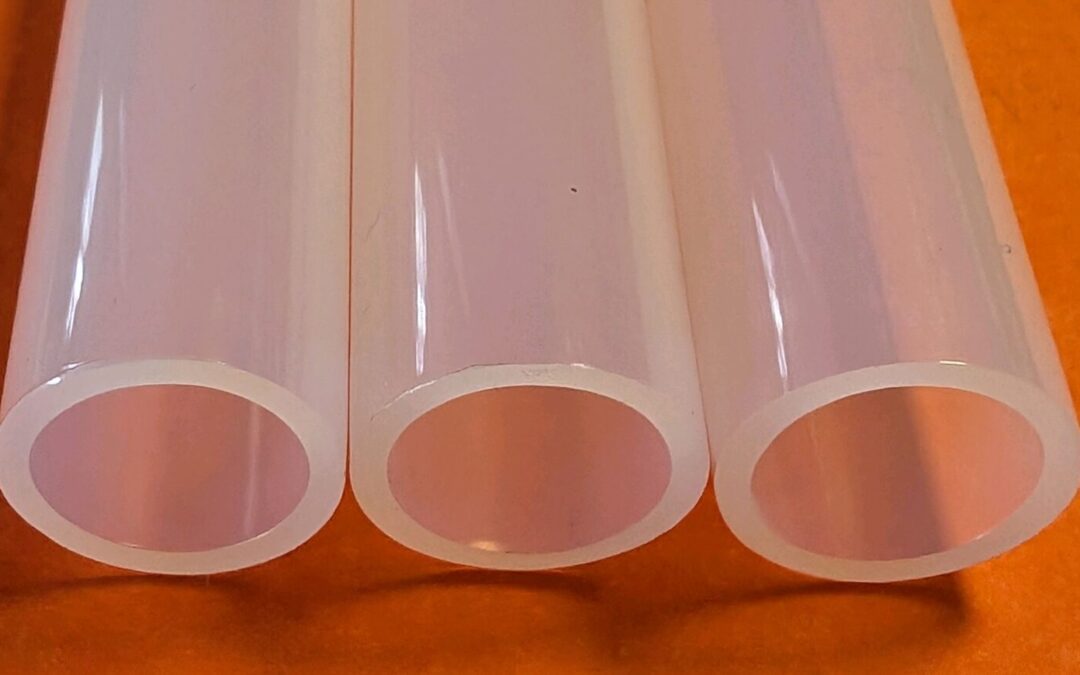 Clear plastic tubes showcasing examples of plastic extrusion, featuring nylon tubing, polysulfone tubing, and custom plastic cores.